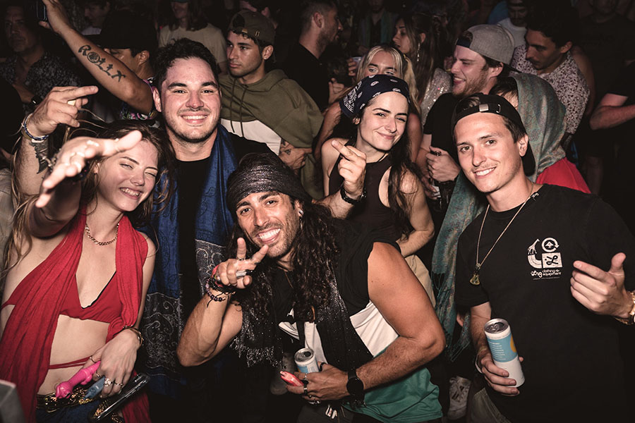 group of people joyfully posing at a music event